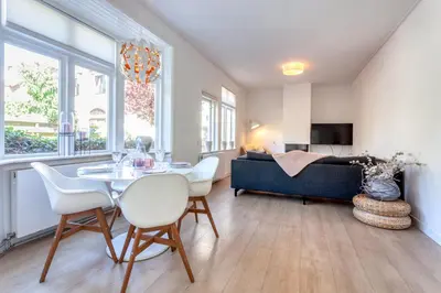 a living room with a table and chairs and a couch at Casa Vos Family Home in Zandvoort
