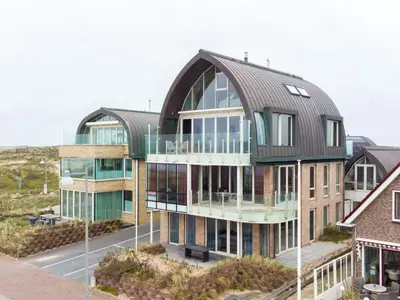 a large building with a metal roof at Holiday Home De Zeeparel by Interhome in Egmond aan Zee