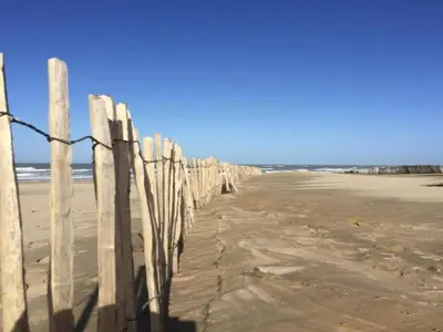 a fence on the beach near the ocean at Holiday Home in Noordwijk near Beach in Noordwijk
