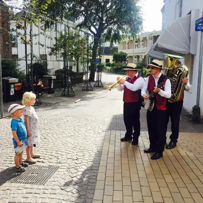 a group of men playing music and a little child at Reumann Holiday Apartments De Schelp 5 in Zandvoort