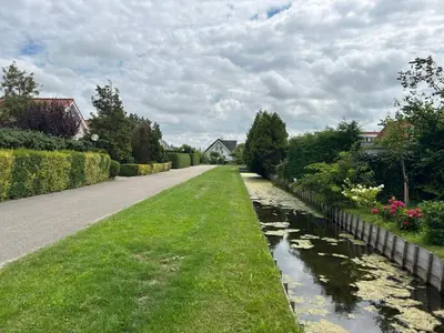 a road leading down a street with a river at Holiday Home Tapuit 8-2 by Interhome in Noordwijk