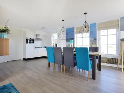 a kitchen and dining room with a table and chairs at Holiday Home Tapuit 8-2 by Interhome in Noordwijk