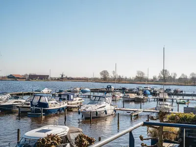 a bunch of boats are docked in the water at Holiday Home Kraaijennest by Interhome in Uitgeest