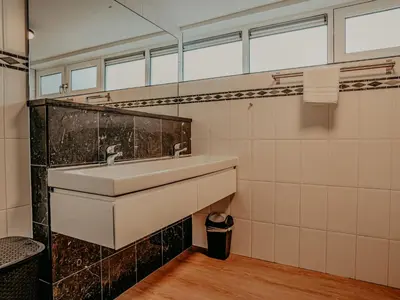 a bathroom with a sink and a mirror at Holiday Home De Woude by Interhome in Uitgeest