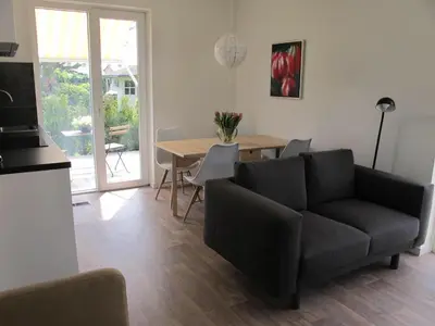 a living room with a couch and a table at La Tulipe in Egmond aan den Hoef