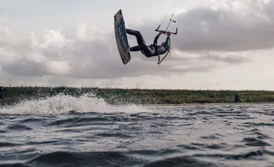 a person doing a trick on a board in the water at The Beach & Town Suite - Free Parking in Zandvoort