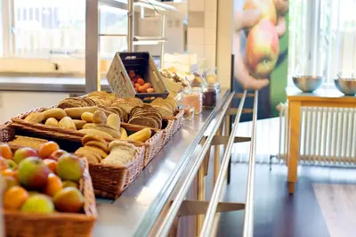 a counter with baskets of apples and other fruits at Stayokay Hostel Heemskerk - fully renovated April 2026 in Heemskerk