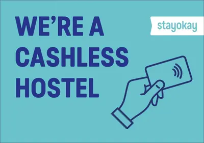 a hand holding a phone with the words were a cashless hospital at Stayokay Hostel Heemskerk - fully renovated April 2026 in Heemskerk