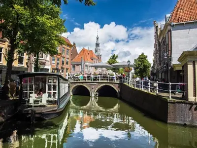 a bridge over a river in a city at Holiday Home in Beemster by Windmill in Middenbeemster