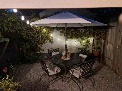 a table and chairs with an umbrella on a patio at Bed & Bentwoud in Benthuizen