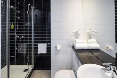 a bathroom with a shower and a sink and a toilet at Holiday Inn Express Amsterdam - Sloterdijk Station by IHG in Amsterdam