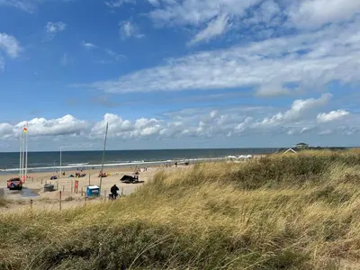a beach with a lot of people and the ocean at Holiday Home Stern Comfort-3 by Interhome in Noordwijkerhout