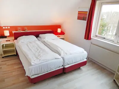 a small bedroom with two beds and a window at Holiday Home Stern Comfort-3 by Interhome in Noordwijkerhout