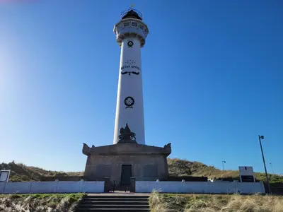a lighthouse on the side of a hill at Zeesterflat 117 in Egmond aan Zee