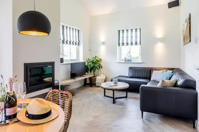 a living room with a couch and a table at De Gouden Spar in Noordwijk