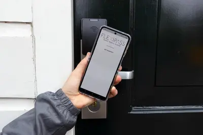 a person holding a smart phone in front of a door at SWEETS - Wiegbrug in Amsterdam