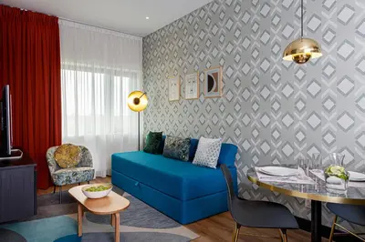 a living room with a blue couch and a table at Boutique Apartments Amsterdam in Amsterdam