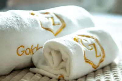a folded towel with a dog on it on a table at Golden Zaan Hotel, Zaandam-Amsterdam in Zaandam