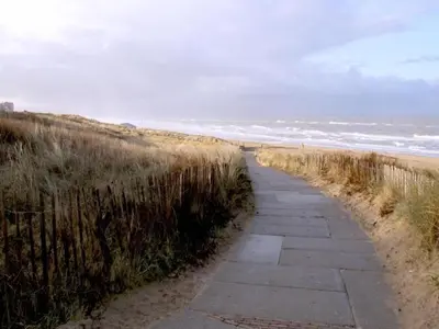 a path along the beach with the ocean in the background at Apartment in Noordwijk near North Sea Beach in Noordwijk