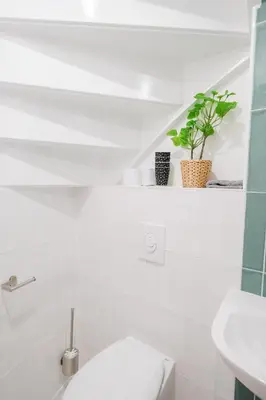 a white bathroom with a toilet and a sink at Tiny Private City Rooms Haarlem in Haarlem