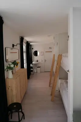 a room with two bunk beds and a hallway at Tiny Private City Rooms Haarlem in Haarlem