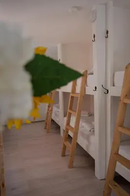 a green umbrella in a room with bunk beds at Tiny Private City Rooms Haarlem in Haarlem
