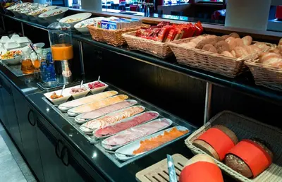 a buffet line with different types of food on display at Bastion Hotel Amsterdam Airport in Hoofddorp
