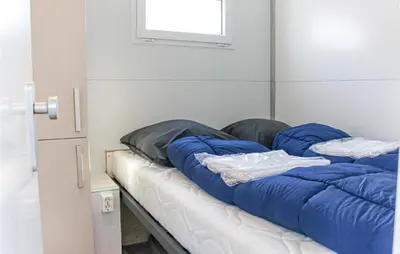 a bed with blue pillows on it in a room at Madrid in Lelystad