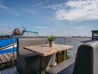 a wooden table on the back of a boat at Harbour Lodge at Uitgeestermeer View in Uitgeest