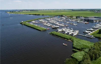 an aerial view of a marina with boats in the water at Cozy Ship In Aalsmeer With Wifi in Aalsmeer