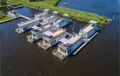 an aerial view of a row of houses on the water at Nice Ship In Aalsmeer With Kitchen in Aalsmeer