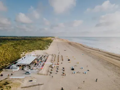 an overhead view of a beach with a crowd of people at Zaras Studios in Zandvoort
