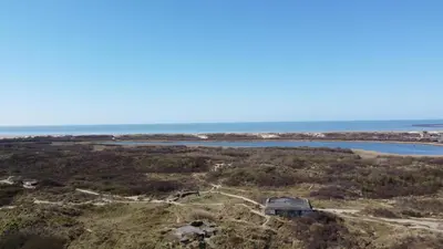 an aerial view of the ocean and a house at Duindoorn 46 in IJmuiden