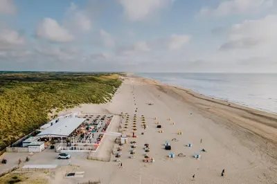 an overhead view of a beach with a crowd of people at Studio the Dunes in Zandvoort