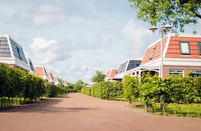 a street in a residential neighbourhood with buildings at Bungalow 6p in Noordwijk