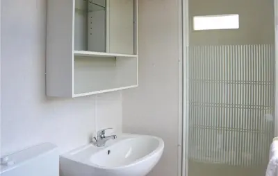 a bathroom with a sink and a mirror and a shower at Huis Nr 1 in Woubrugge
