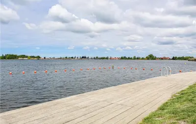 a dock with orange balls in the water at Huis Nr 4 in Woubrugge