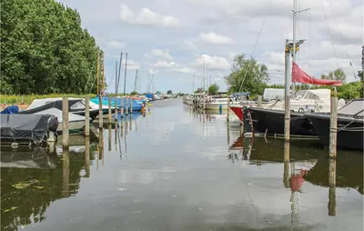 a group of boats docked in a marina at Huis Nr 3 in Woubrugge