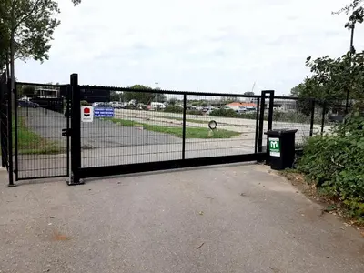 a black fence with a trash can in front of it at Motor Yacht Amstelle in Amsterdam