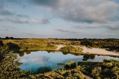 an aerial view of a lake in a field at Green Happiness With Private Parking in Zandvoort