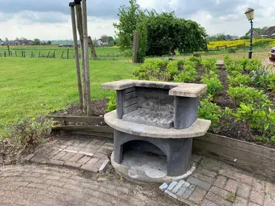a stone bench sitting in the middle of a garden at Christinahoeve Logies in Boskoop