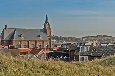 a group of buildings with a church and a tower at Villa Prinsenhof # Tweeëntwintig in Bergen