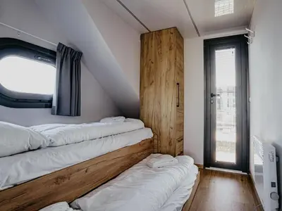 a room with three beds on the wall at Holiday Home Campi 400 by Interhome in Uitgeest