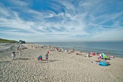a large group of people on a beach at Hotelhuisje Warmenhuizen #D in Warmenhuizen