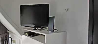 a flat screen tv sitting on top of a white cabinet at Hotelhuisje Warmenhuizen #E in Warmenhuizen