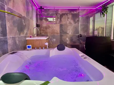 a bathroom with a large tub with purple lighting at Ferienhaus Genießen am Meer mit Wellnesszugang in Egmond aan Zee