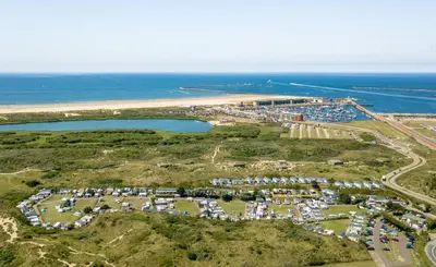 an aerial view of a parking lot next to the ocean at Chalet Ibiza in de duinen van IJmuiden aan Zee in IJmuiden