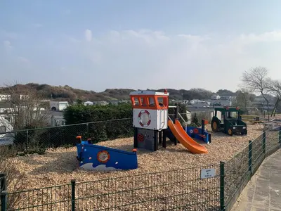 a playground with a slide and a play structure at Chalet Formentera in de duinen van IJmuiden aan Zee in IJmuiden