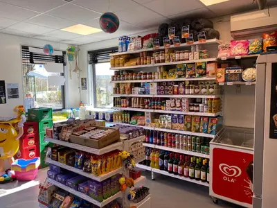 a store aisle with a lot of food and drinks at Chalet Formentera in de duinen van IJmuiden aan Zee in IJmuiden