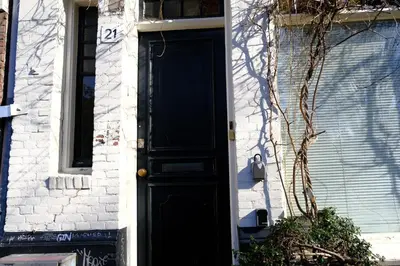 a black door on the side of a building at Eelhouse private studio in Amsterdam